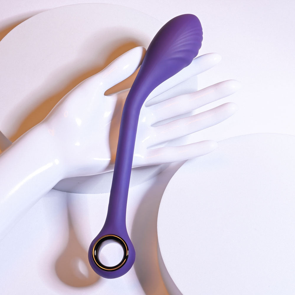 Playboy Pleasure SPOT ON poseable G-Spot vibrator displayed on a hand, showcasing its sleek design and silicone material.