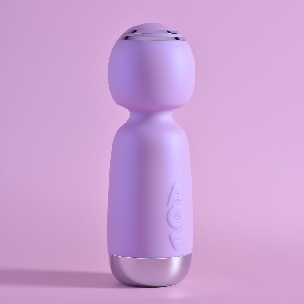 Playboy Pleasure ROYAL MINI - Lilac 12.5 cm USB Rechargeable Mini Wand Vibrator on a pastel pink background.