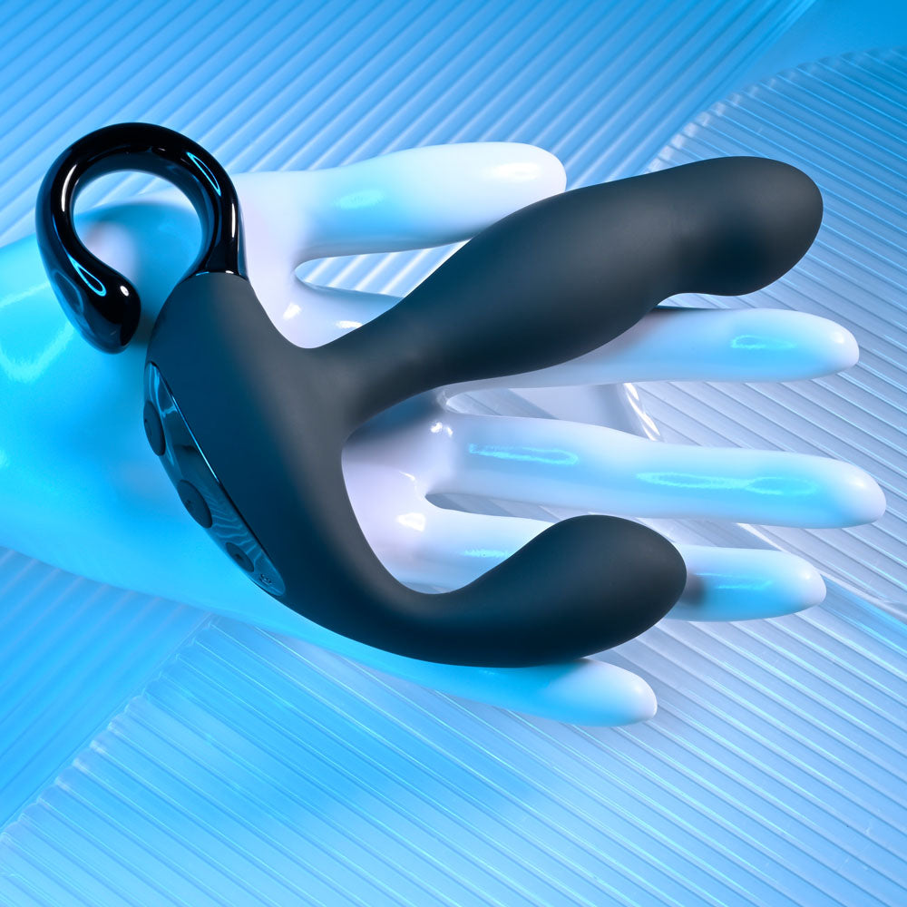 Playboy Pleasure COME HITHER - 13.2 cm USB Rechargeable Vibrating Prostate Massager with Wireless Remote Control on a hand.