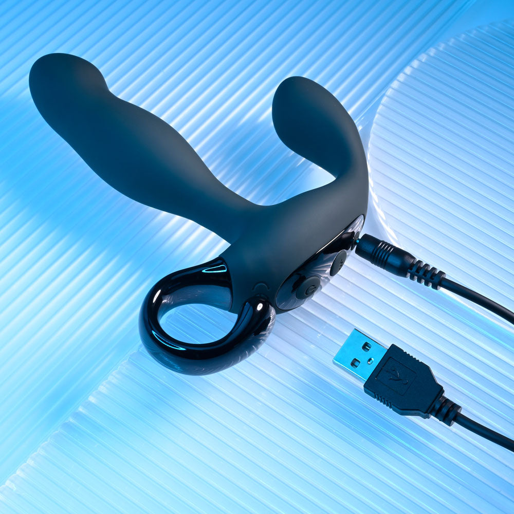 Playboy Pleasure COME HITHER - 13.2 cm USB Rechargeable Vibrating Prostate Massager with Wireless Remote Control on a blue background.