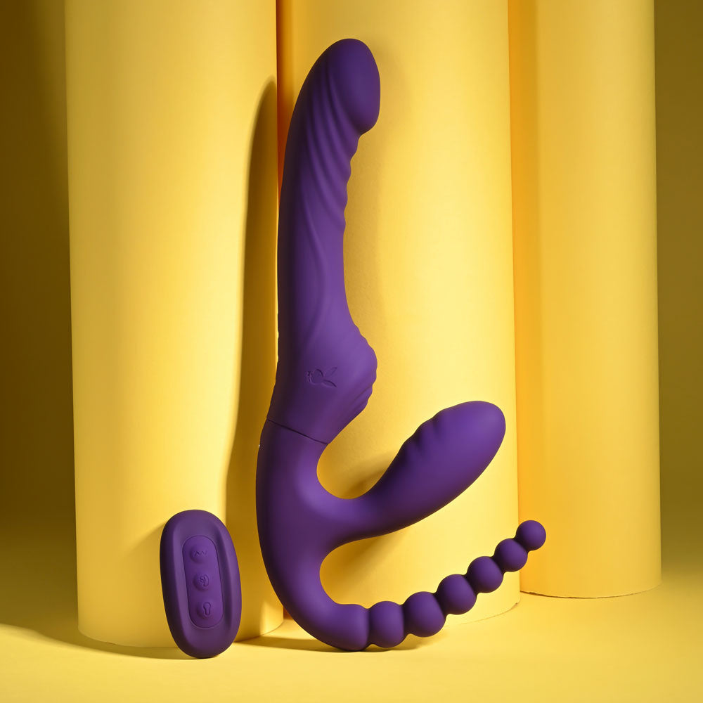 Playboy Pleasure HUG IT OUT - 29 cm USB Rechargeable Strapless Strap-On on a yellow background.