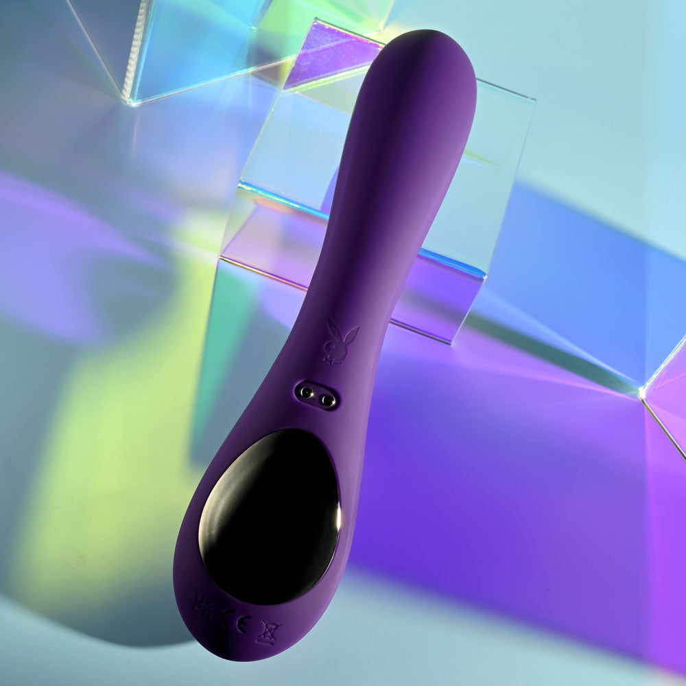 Playboy Pleasure ON REPEAT - 19.7 cm USB Rechargeable Rabbit Vibrator in purple against a colorful background.