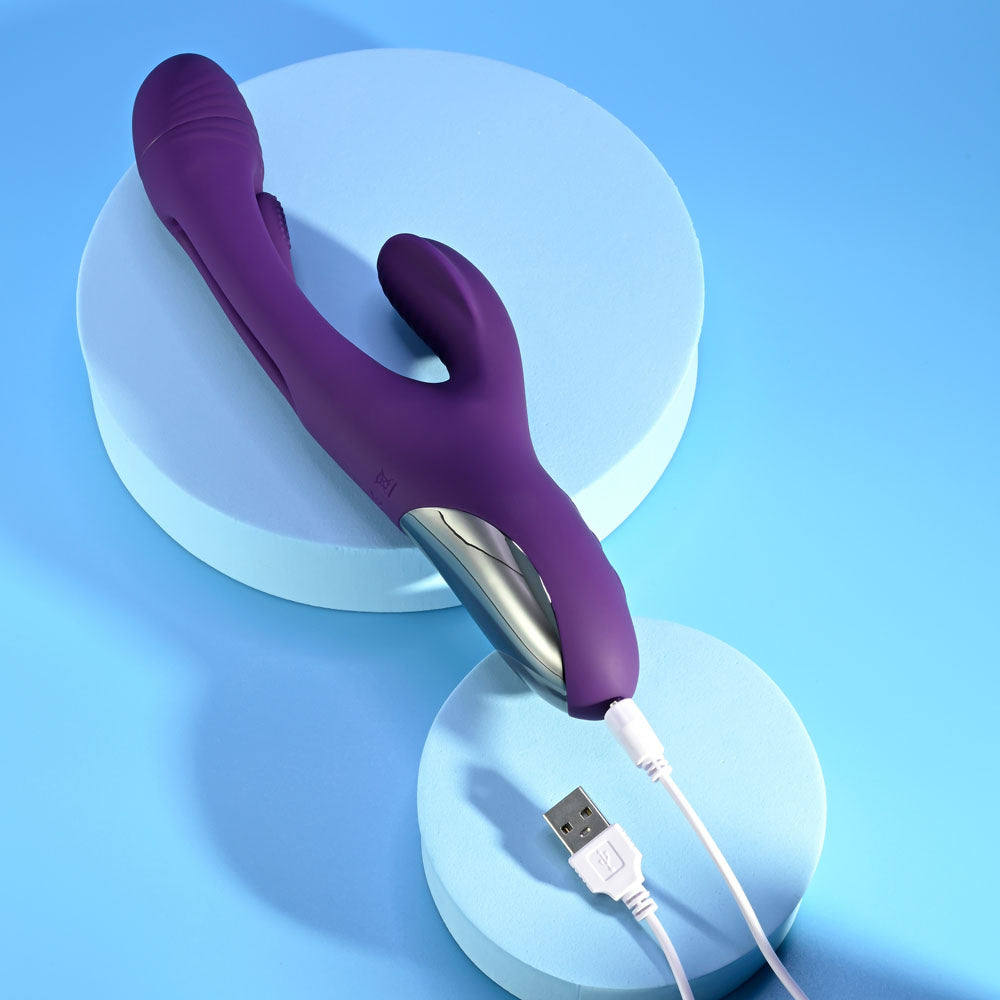 Playboy Pleasure THE THRILL - 24.4 cm USB Rechargeable Rabbit Vibrator on blue background with charging cable.