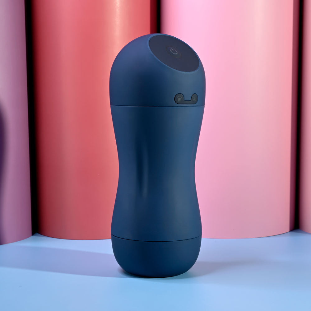 Playboy Pleasure GUSTO - USB Rechargeable Vibrating & Sucking Masturbator in a sleek design against pastel backgrounds.