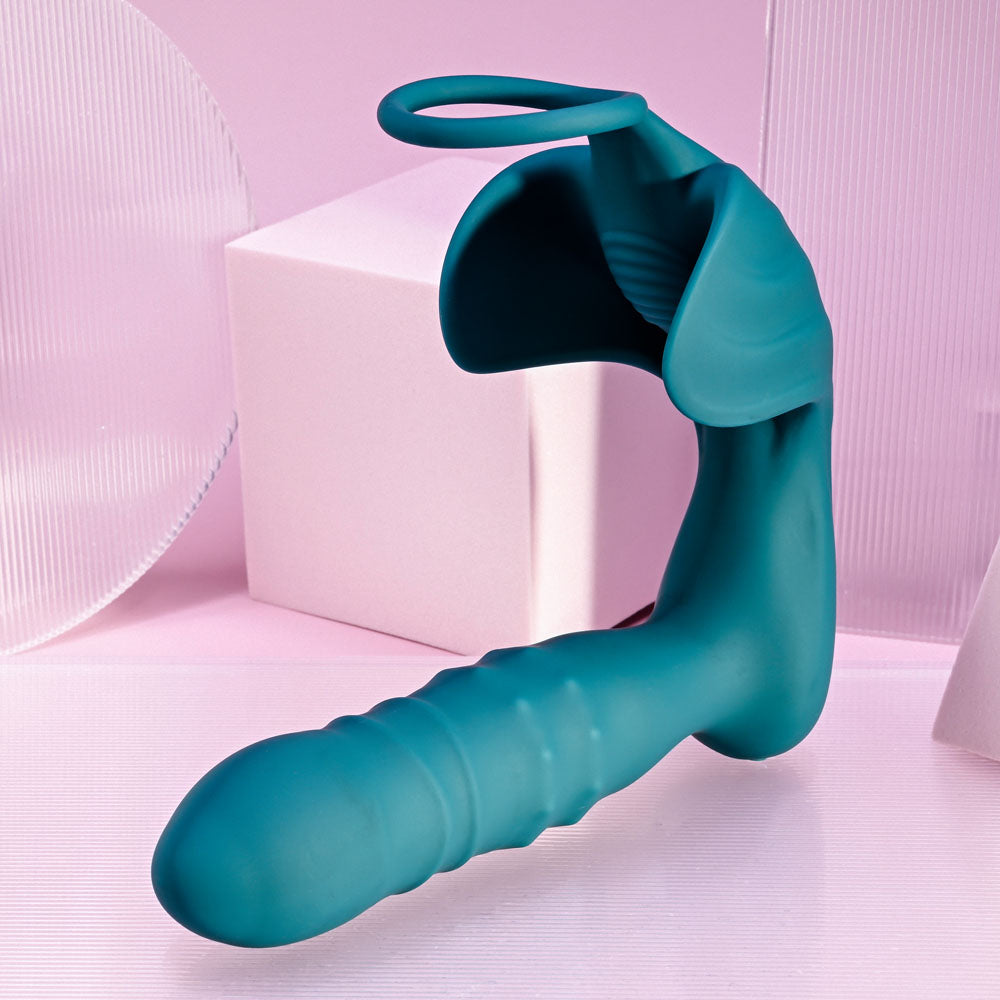 Playboy Pleasure BRING IT ON - Teal USB Rechargeable Thrusting Anal Plug with Cock Ring on pink background.