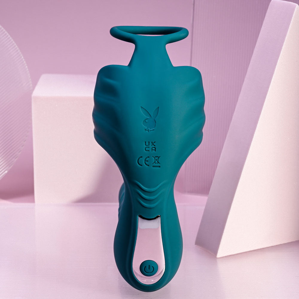 Playboy Pleasure BRING IT ON - Teal USB Rechargeable Thrusting Anal Plug with Cock Ring on a display.