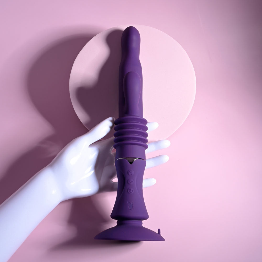 Playboy Pleasure HOPPY ENDING - 29.2 cm USB Rechargeable Thrusting Rabbit Vibrator on a pink background.