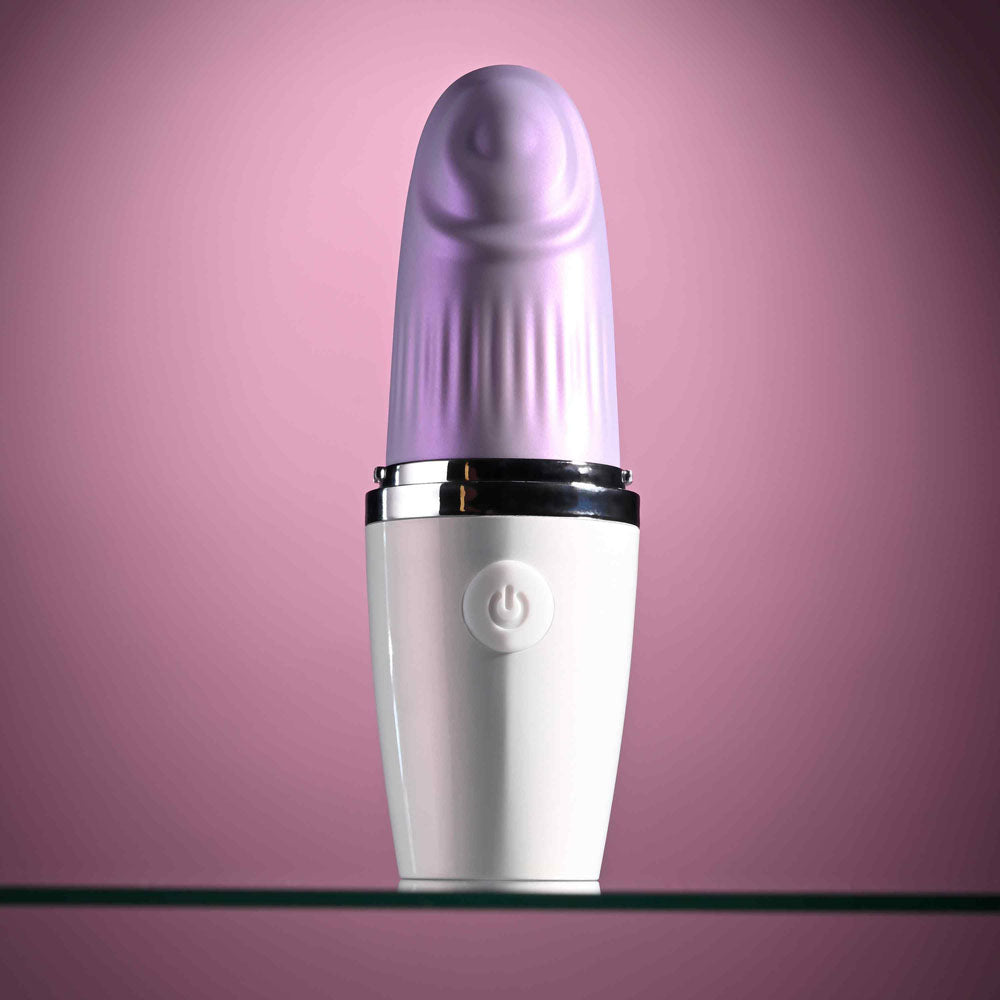 Playboy Pleasure GETAWAY - White/ 14.2 cm USB Rechargeable Tapping Stimulator on a reflective surface.
