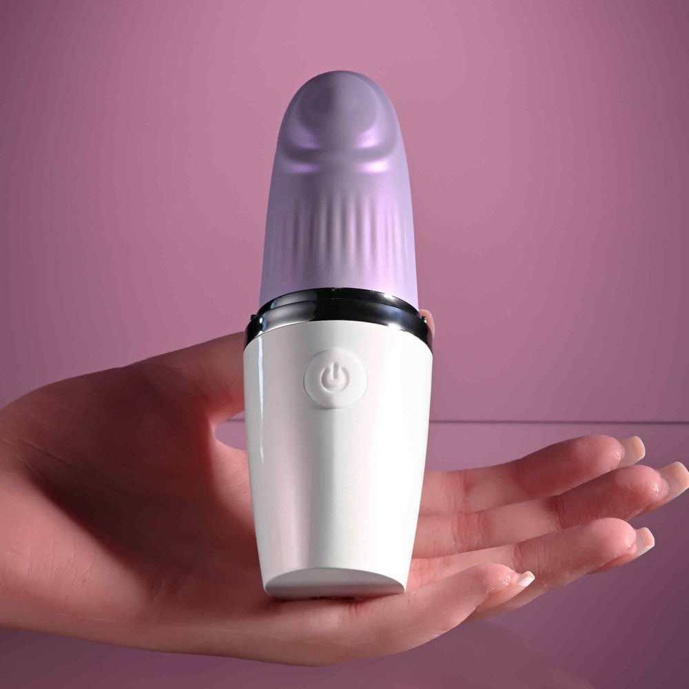 Playboy Pleasure GETAWAY - White/ 14.2 cm USB Rechargeable Tapping Stimulator held in a hand against a pink background.