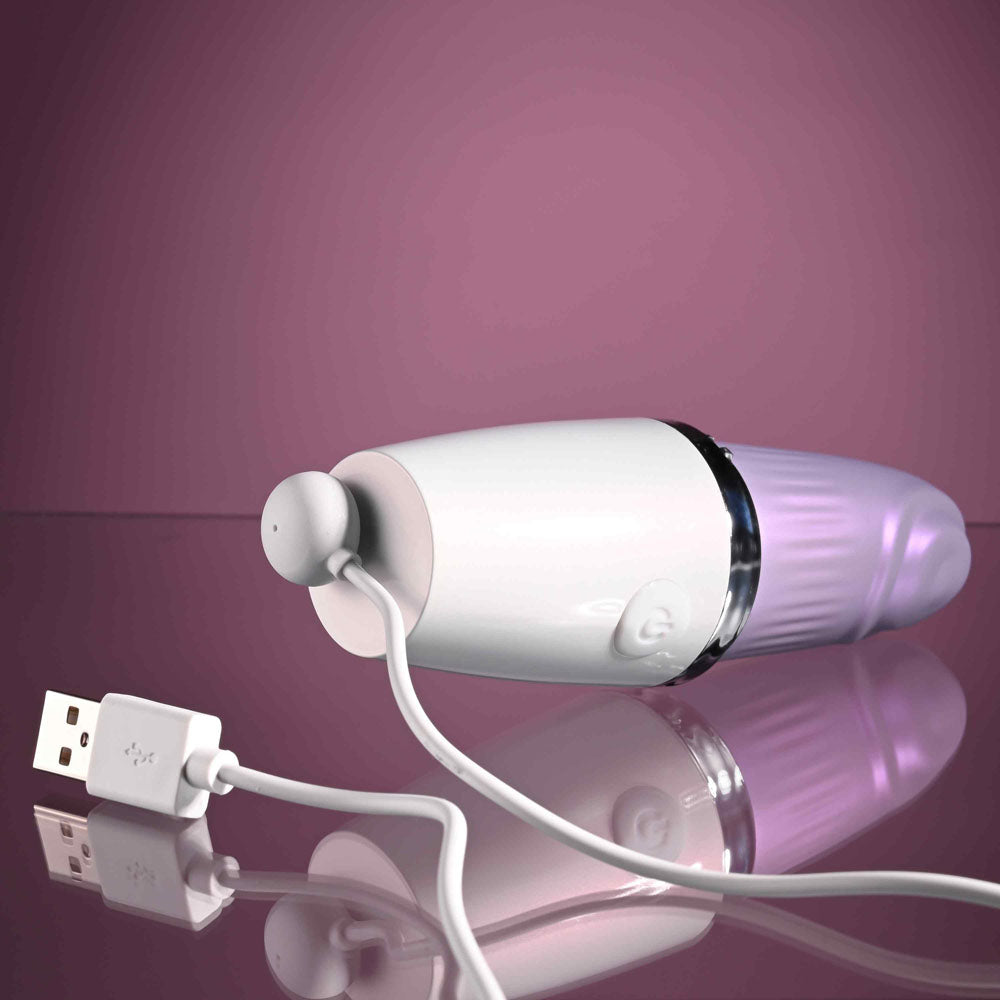 Playboy Pleasure GETAWAY - White/ 14.2 cm USB Rechargeable Tapping Stimulator on a reflective surface with USB charging cable.