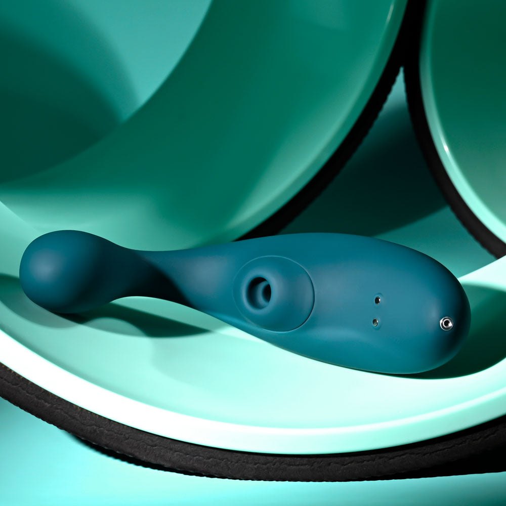 Playboy Pleasure CHARMER -  USB Rechargeable Vibrator with Clitoral Suction on a teal background.