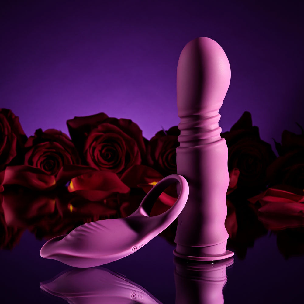 Playboy Pleasure MATCH PLAY -  USB Rechargeable with C-Ring Attachment on a reflective surface next to red roses.