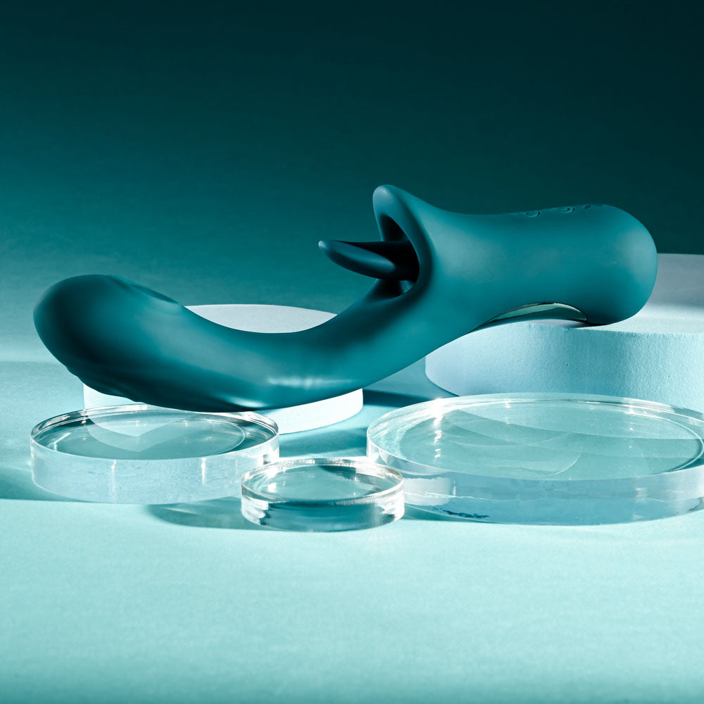 Playboy Pleasure HARMONY - 22.9 cm USB Rechargeable Vibrator with Clitoral Flicker on display with glass discs.
