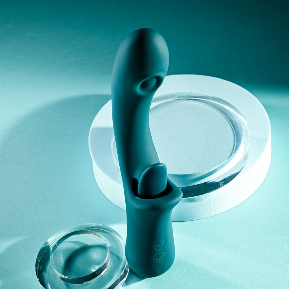 Playboy Pleasure HARMONY - 22.9 cm USB Rechargeable Vibrator with Clitoral Flicker on a teal background.
