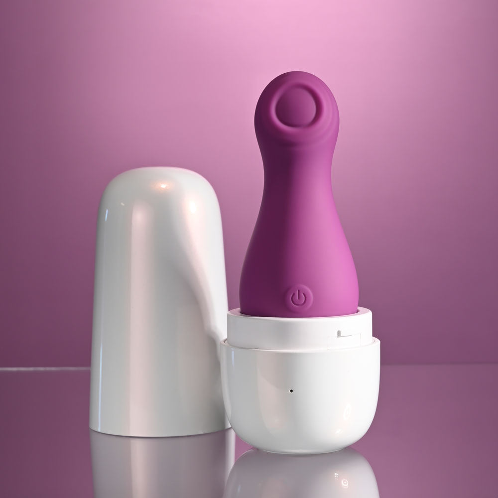 Playboy Pleasure THE JET SET - TAPPING - 10.2 cm Tapping Stimulator with Charging Case on reflective surface.
