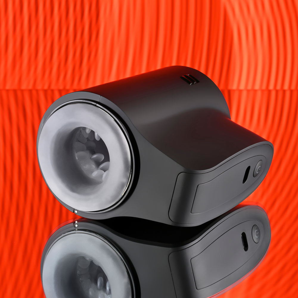 Playboy Pleasure COME ALONG - USB Rechargeable Vibrating Stroker on a reflective surface with a vibrant background.