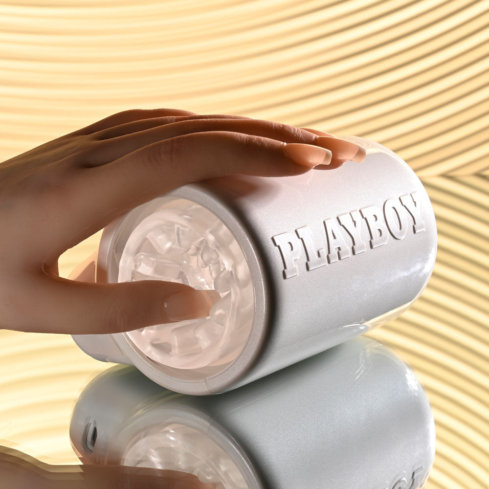 Playboy Pleasure SPIN DOCTOR - USB Rechargeable Vibrating & Spinning Stroker showcased with a hand on its sleek design.