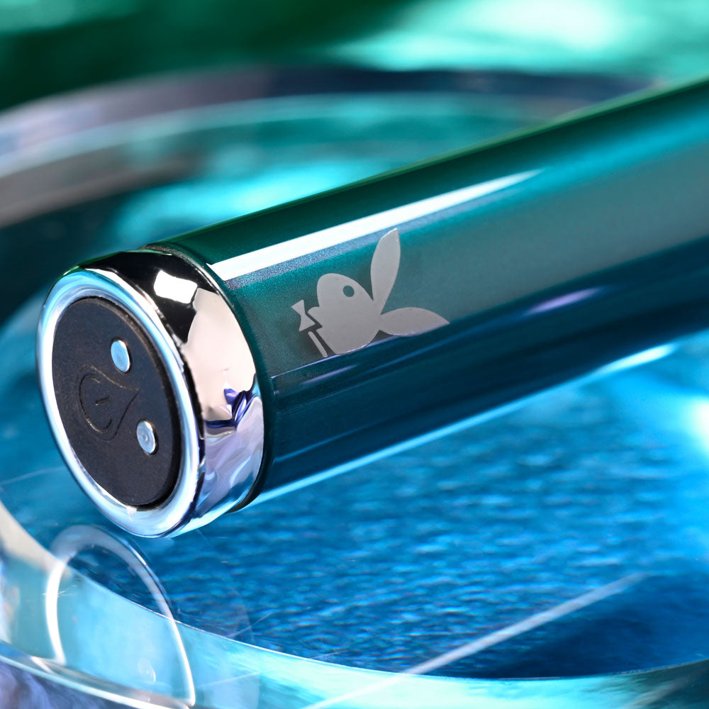 Playboy Pleasure EMERALD -  9.1 cm USB Rechargeable Glass Tipped Bullet resting on a reflective surface.