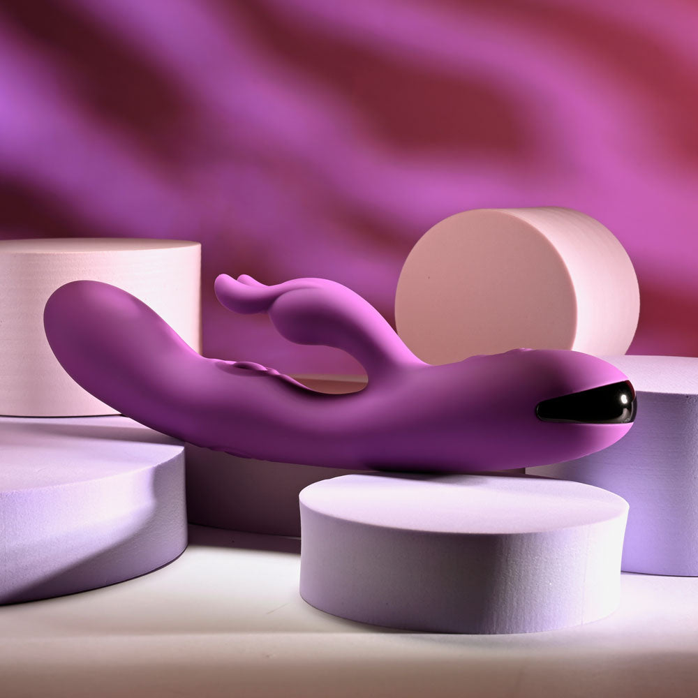 Playboy Pleasure BUSY BUNNY - 22.6 cm USB Rechargeable Rabbit Vibrator with Tapping Shaft on display.