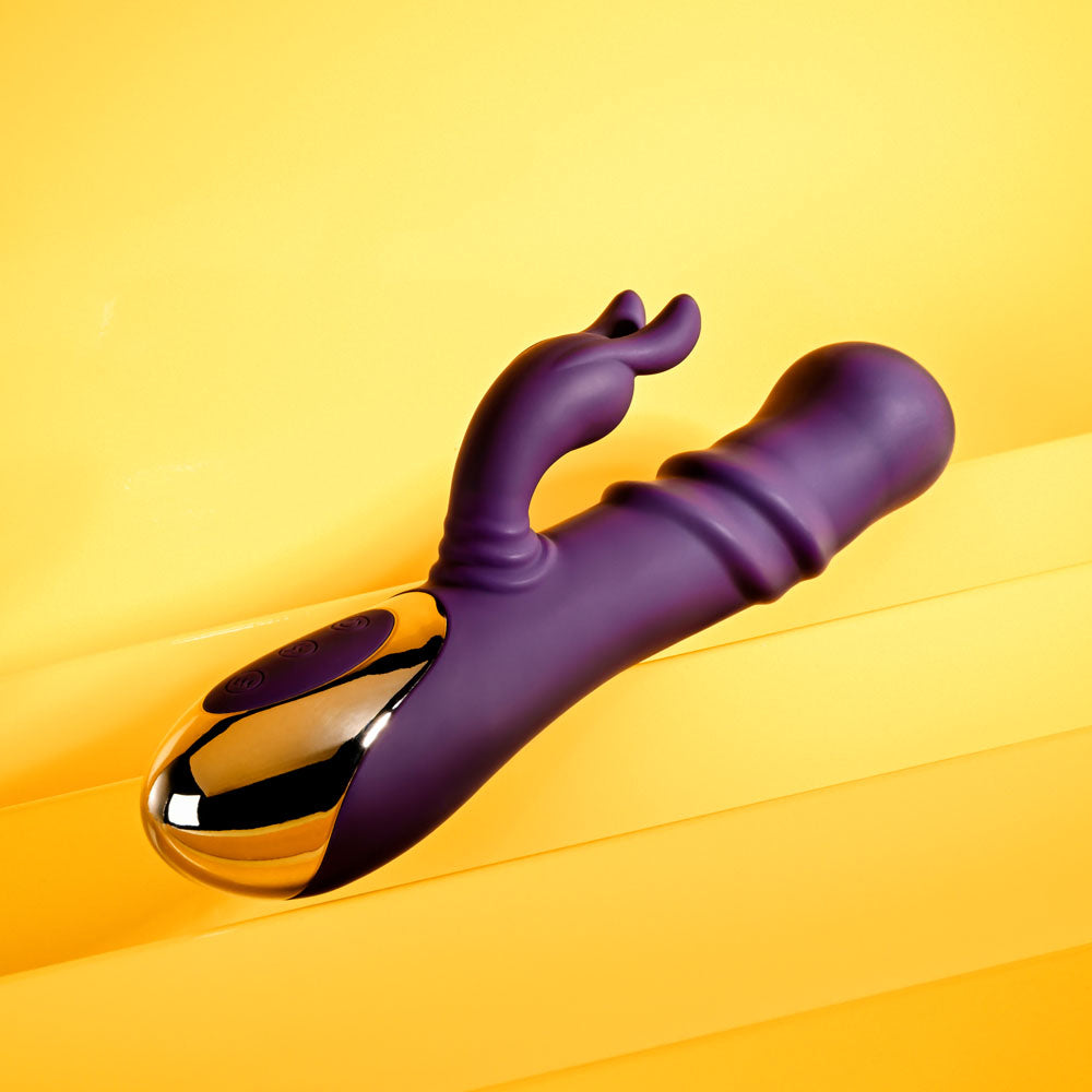 Playboy Pleasure BUNNY PUNCH - 24.4 cm USB Rechargeable Twirling Rabbit Vibrator on yellow background.