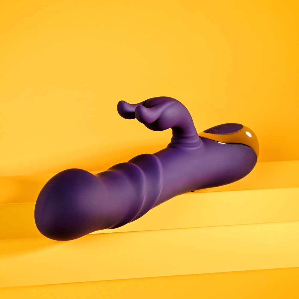 Playboy Pleasure BUNNY PUNCH - 24.4 cm USB Rechargeable Twirling Rabbit Vibrator on a vibrant yellow background.