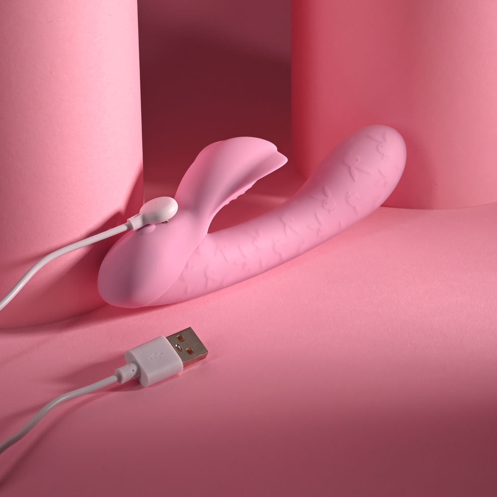 Playboy Pleasure RABBIT PARTY - 15.2 cm USB Rechargeable Rabbit Vibrator on a pink background with charging cable.