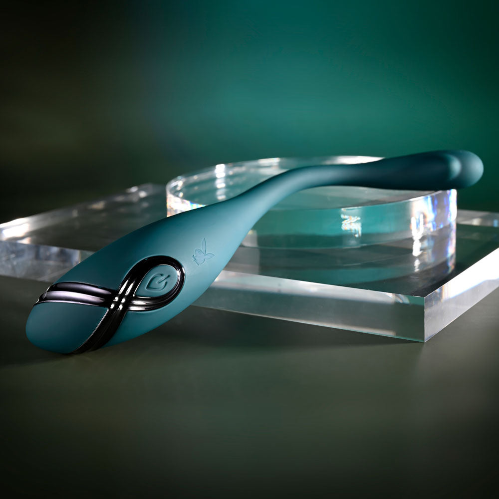 Playboy Pleasure PINPOINT PERFECTION - 19.3 cm USB Rechargeable Poseable Vibrator on a reflective surface.