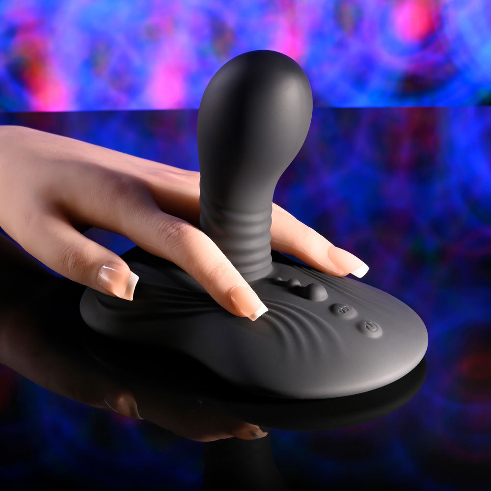 Playboy Pleasure SITTIN & SPINNIN - USB Rechargeable Spinning Vibrator & Grinder Pad with Remote on a sleek surface.