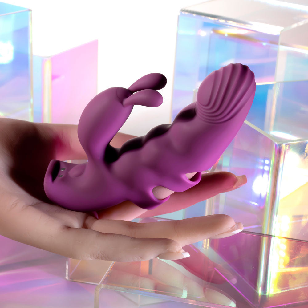 Playboy Pleasure LEND A HAND -  USB Rechargeable Finger Vibrator in hand, showcasing its design and features.
