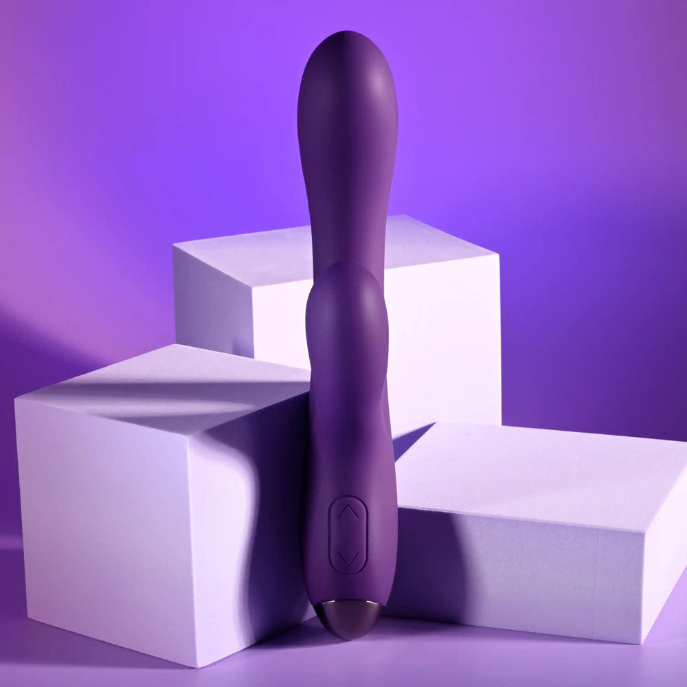 Playboy Pleasure NEW CRUSH - 20.6 cm USB Rechargeable Rabbit Vibrator on purple background with geometric shapes.