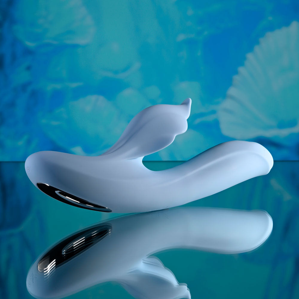 Playboy Pleasure IN BLOOM - 23.5 cm USB Rechargeable Thrusting Tapping & Heating Dual Vibrator displayed on reflective surface.