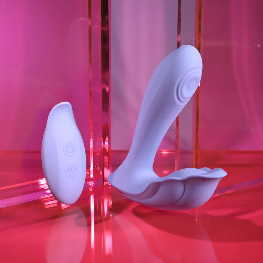 Playboy Pleasure LILAC FANTASY - 13.5 cm USB Rechargeable Tapping Vibrator with Remote in a vibrant setting.