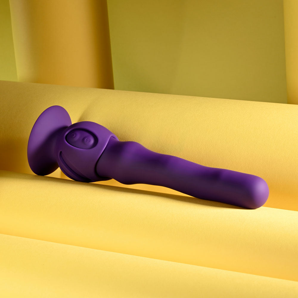 Playboy Pleasure WIGGLE IT, 23.9 cm rechargeable wiggling vibrator on a yellow background.