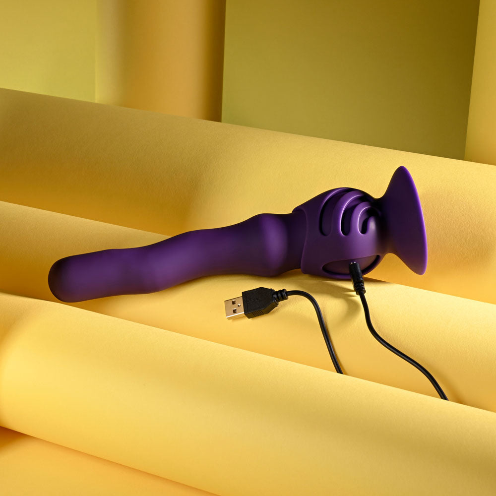 Playboy Pleasure WIGGLE IT - 23.9 cm USB Rechargeable Wiggling Vibrator on a yellow background.