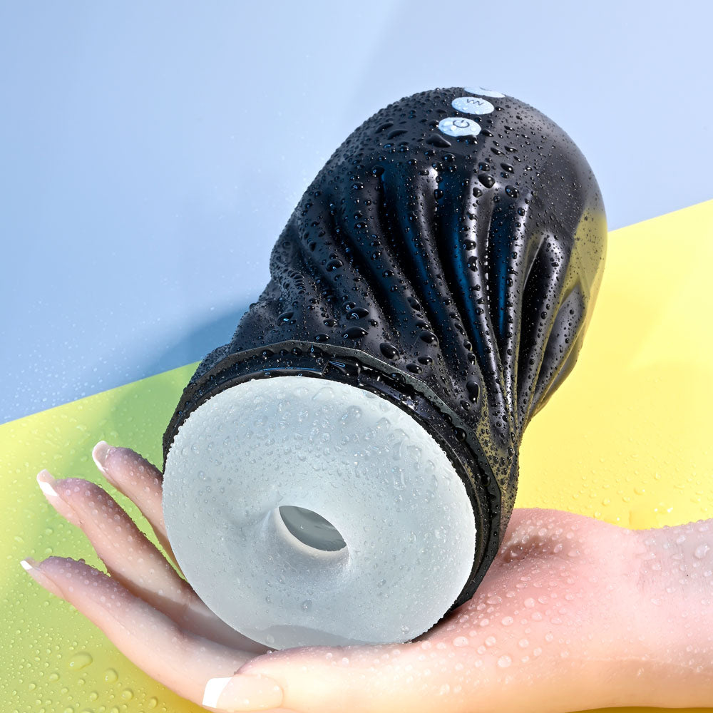 Playboy Pleasure SOLO - USB Rechargeable Vibrating and Sucking Stroker in hand, showcasing its soft texture and water-resistant design.