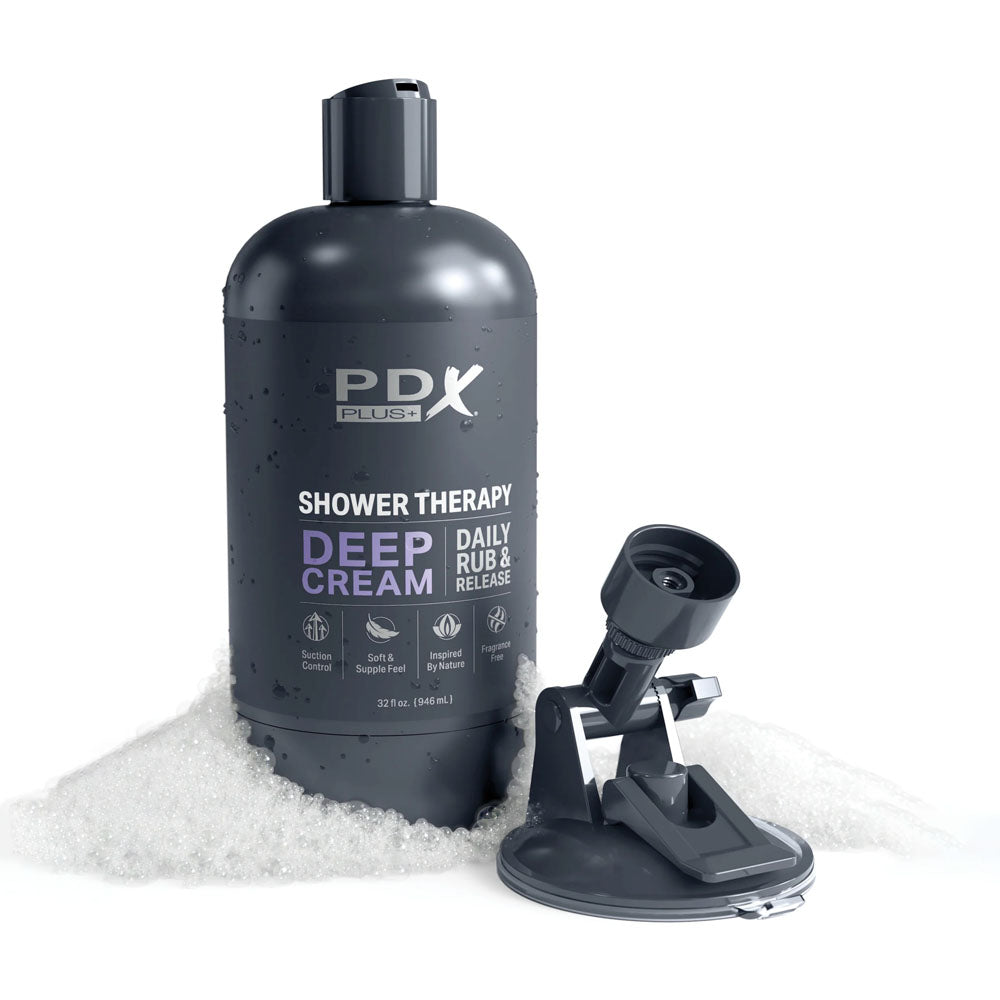 PDX Plus Shower Therapy - Deep Cream - Frosted - Discreet Stroker with Suction Base placed in a bath setting with bubbles.