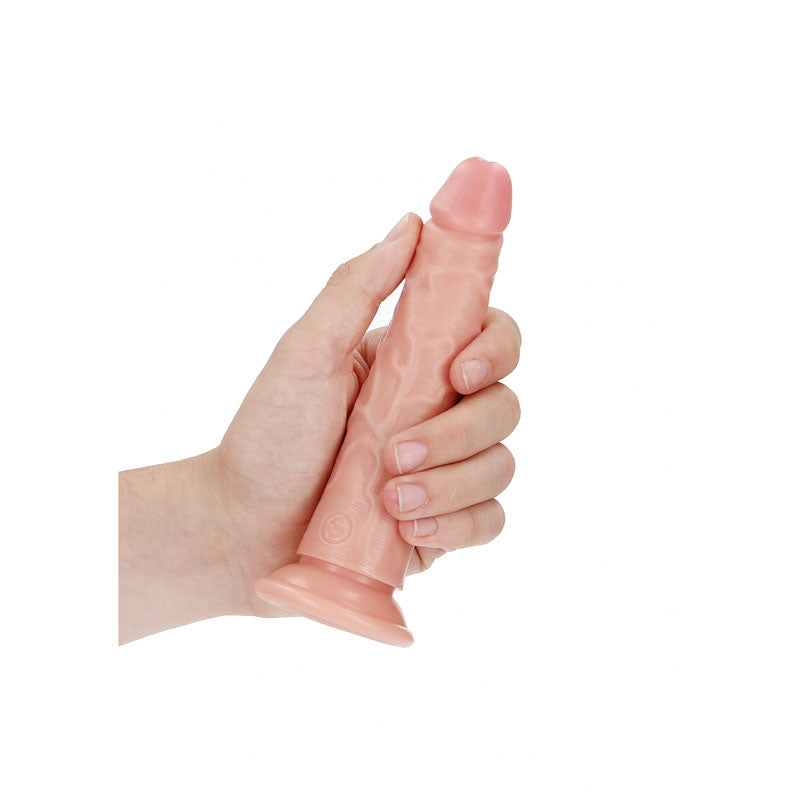 REALROCK Realistic Slim Dildo for g-spot stimulation held in hand, showcasing its soft texture and natural look.