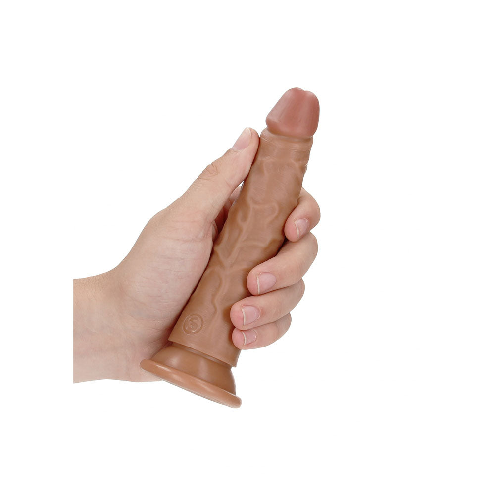REALROCK Realistic Slim Dildo without Balls - 15.5 cm - Tan 15.5 cm (6'') Dong held in a hand.