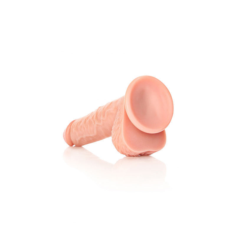 REALROCK Straight Realistic Dildo with Balls - 20.5 cm - 20.5 cm (8'') Dong on a reflective surface.