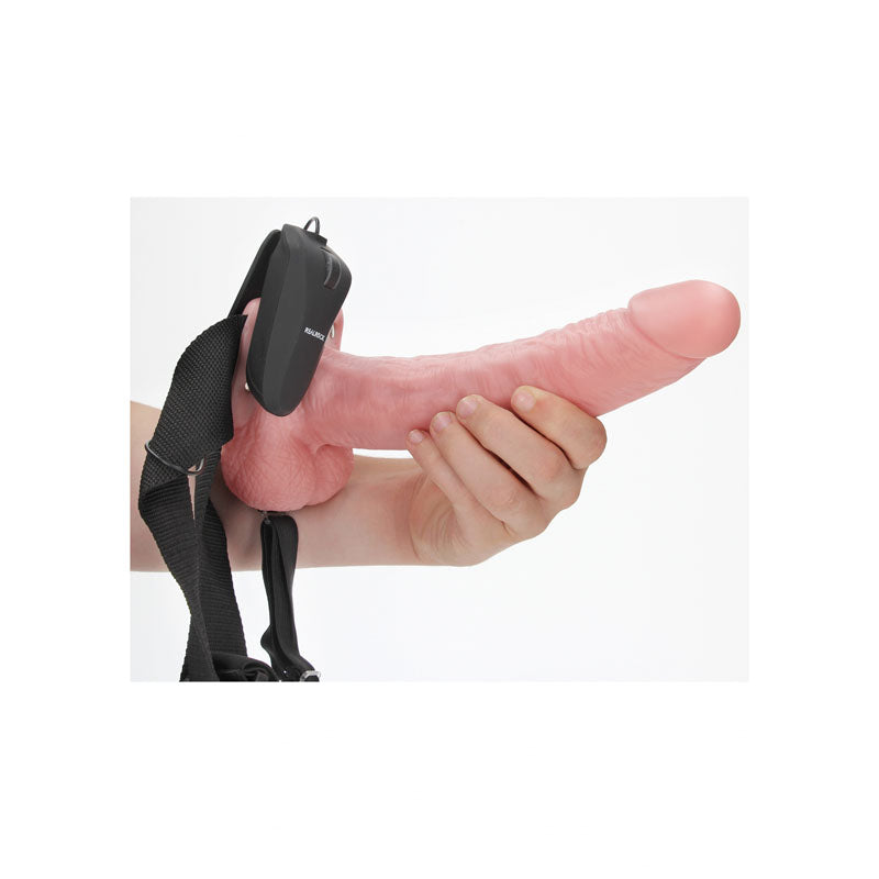 REALROCK Vibrating Hollow Strapon + Balls - 23cm  -  23 cm Vibrating Hollow Strap-On in hand with adjustable harness.