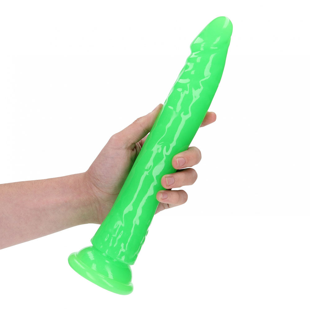 REALROCK 29 cm Slim Glow in the Dark Neon -  - Glow in Dark  29 cm (11'') Dong held in hand, showcasing its vibrant glow.