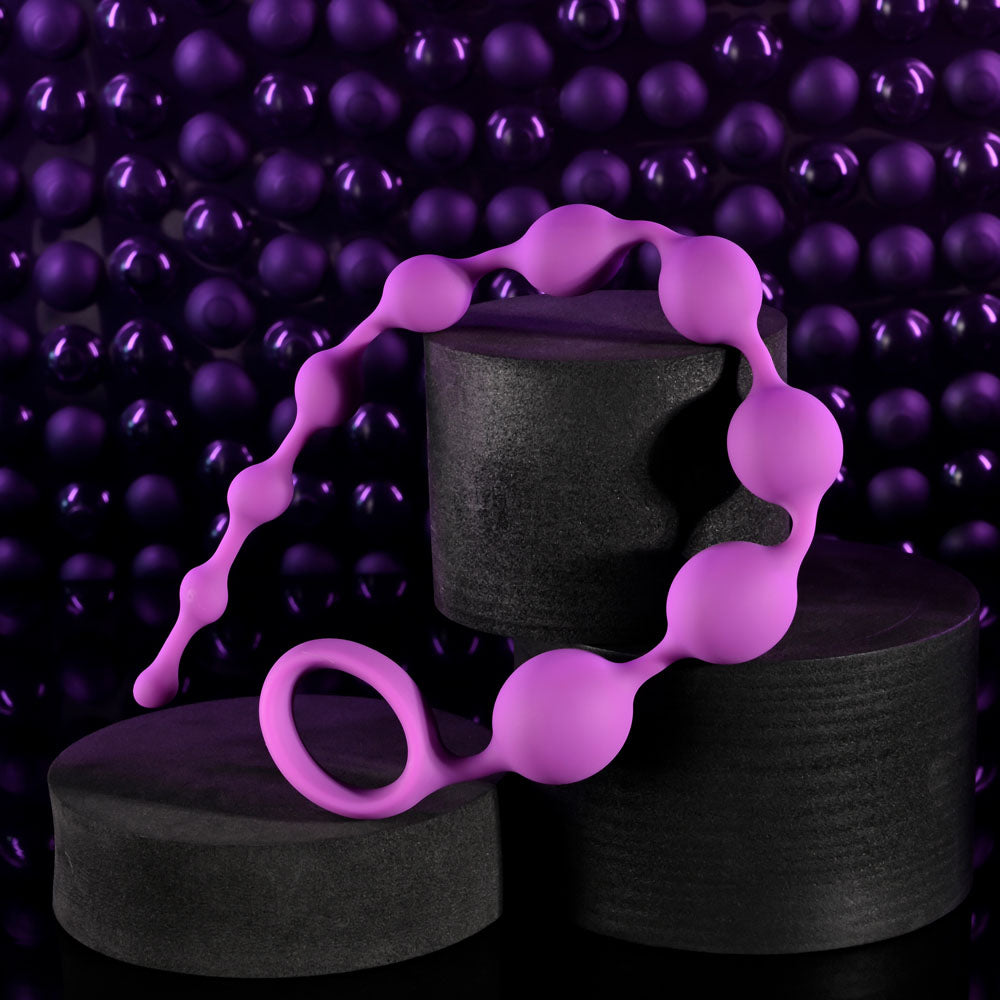 Selopa BEADED ADVENTURE -  35.5 cm Anal Beads elegantly displayed on textured black and purple background.