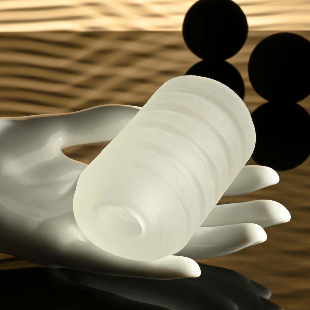 Selopa RING ME UP - Stroker shown in a hand, demonstrating its squishy, soft design with deep grooves for grip.
