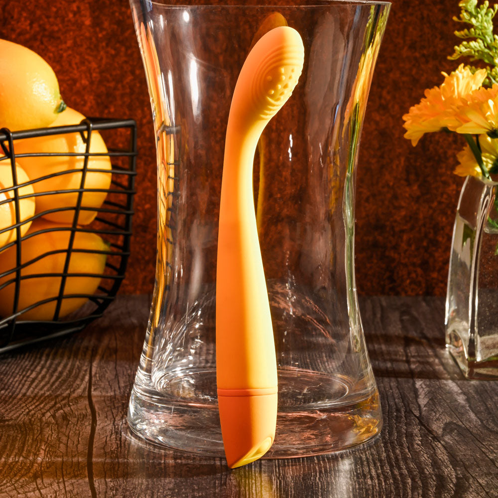 Selopa LEMON SQUEEZE -  18.4 cm USB Rechargeable Vibrator displayed next to oranges in a glass vase.