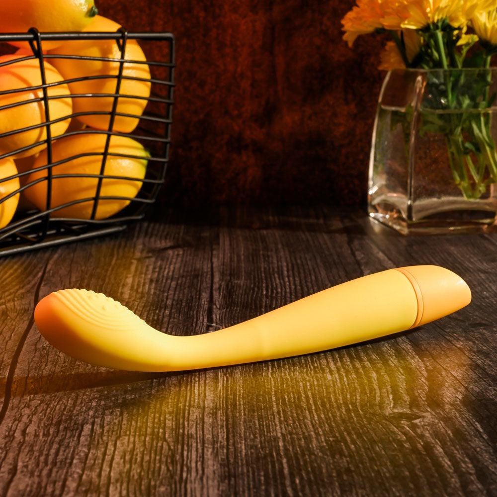 Selopa LEMON SQUEEZE - 18.4 cm USB Rechargeable Vibrator on wooden table with basket of lemons in background.