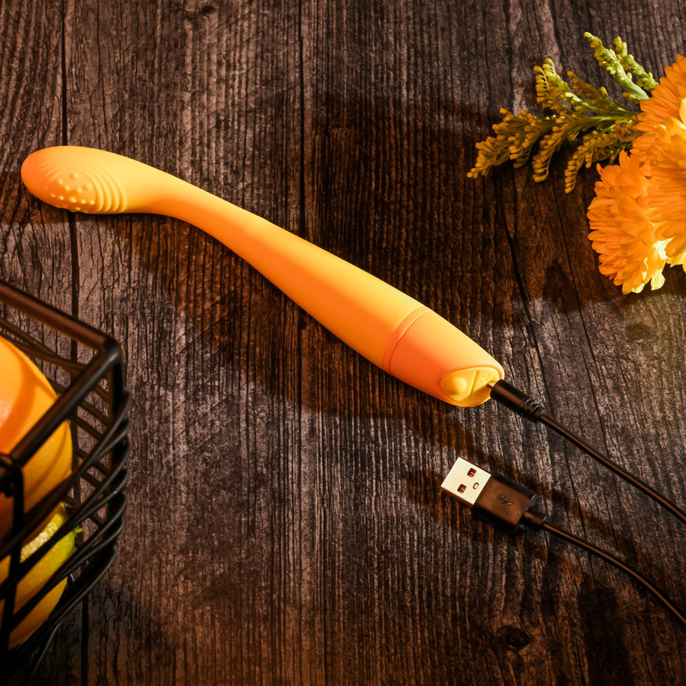 Selopa LEMON SQUEEZE -  18.4 cm USB Rechargeable Vibrator on wooden surface with USB charging cable.