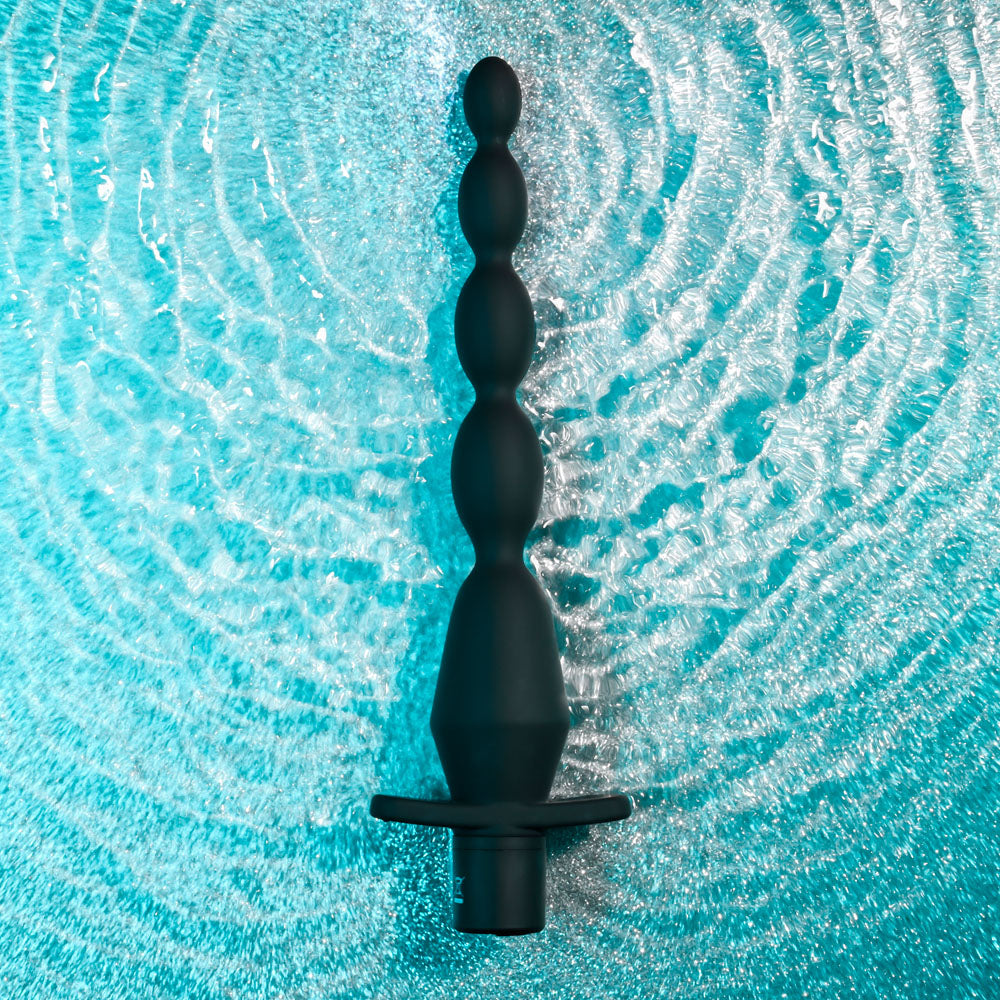 Selopa VIBRATING BUTT BEADS - 22 cm USB Rechargeable Vibrating Anal Beads on a wet surface.