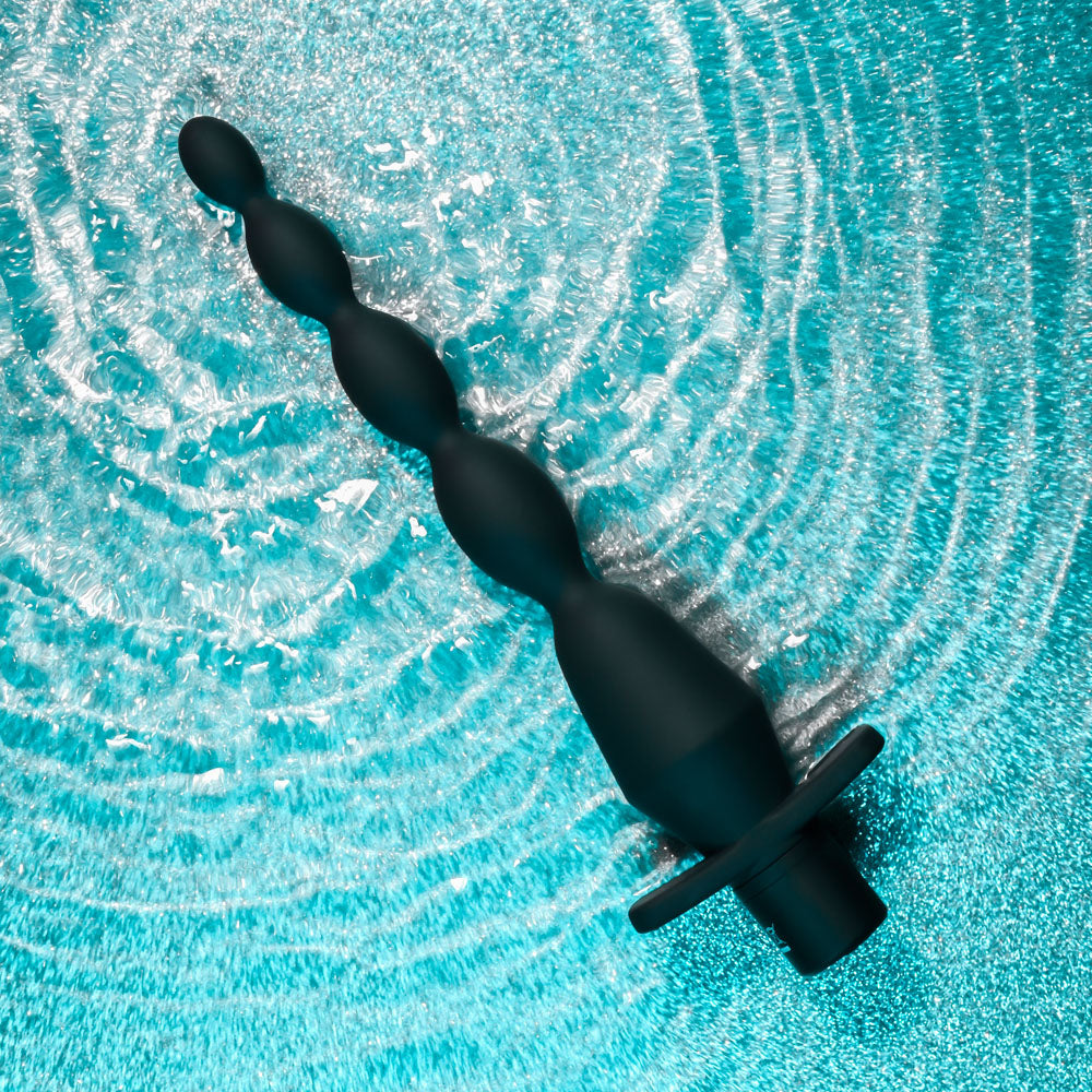 Selopa VIBRATING BUTT BEADS -  22 cm USB Rechargeable Vibrating Anal Beads on a textured aqua background.
