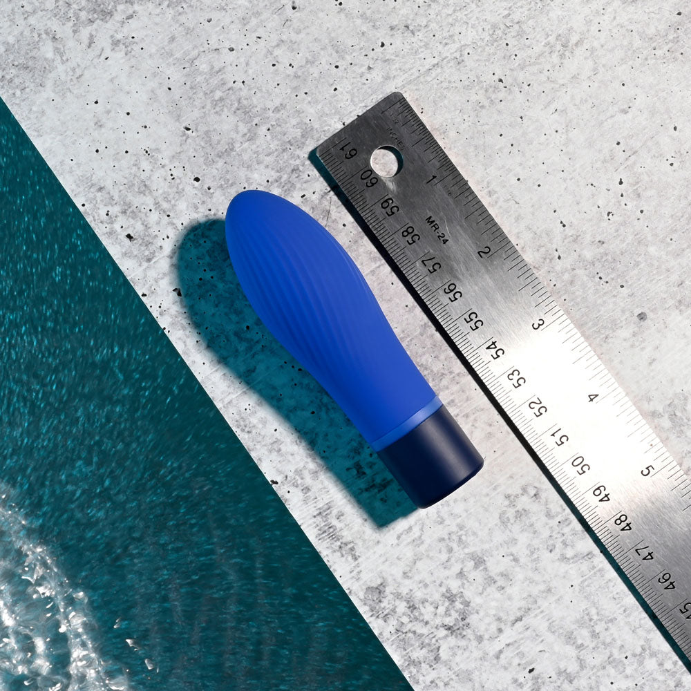 Selopa COBALT CUTIE - a vibrant blue vibrating toy placed next to a ruler on a concrete surface.