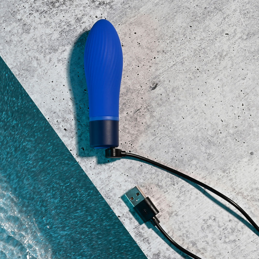 Selopa COBALT CUTIE - vibrant blue USB rechargeable vibrator on a textured surface for intimate essentials for her.